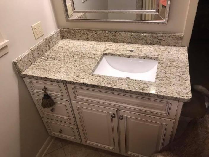 With the simple addition of this vintage-style cabinet paired with a granite counter, this bathroom is just stunning! 