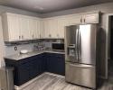 White cabinets paired with navy blue adds depth and high-end appeal to this modern-style kitchen. 