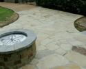 Complete with a gorgeous fire pit, this natural stone patio is absolutely breathtaking! 